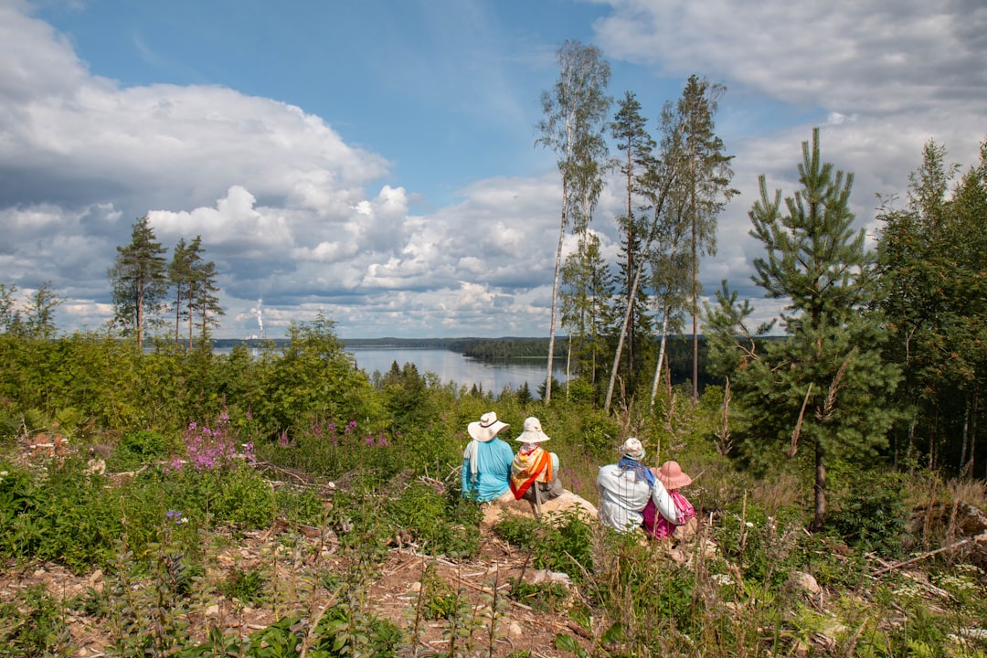 four people sitting on rock boulders